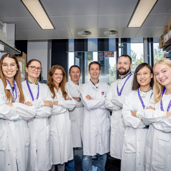 a group of lab workers having a photo taken for pancreatic cancer uk