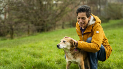 Woman out walking her dog, a golden Labrador