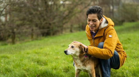 Woman out walking her dog, a golden Labrador