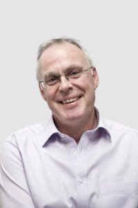 man smiling at camera with white background Dr Iain Frame