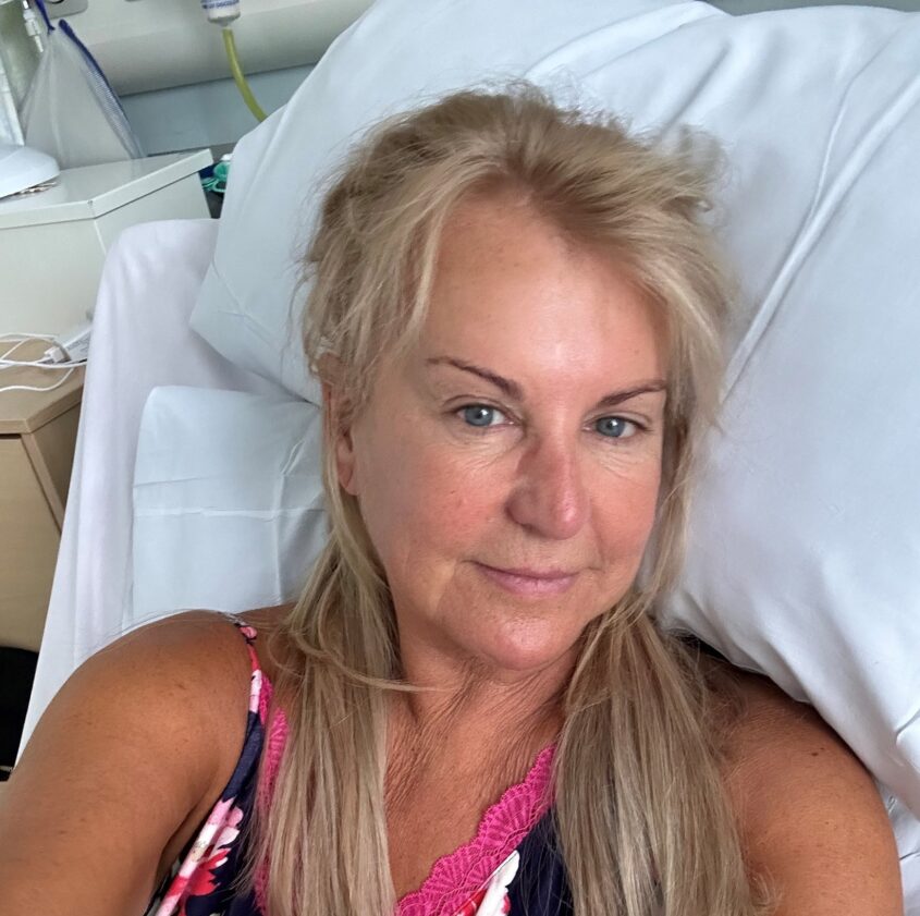 Woman in a hospital bed looking well