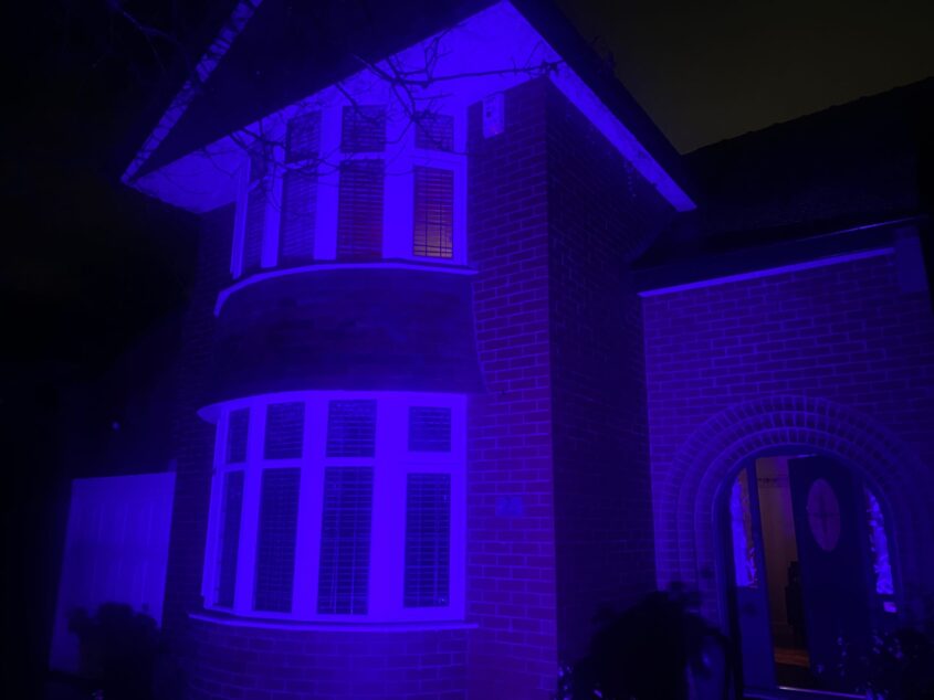 A detached house that has been lit up purple for Purple Lights for pancreatic cancer