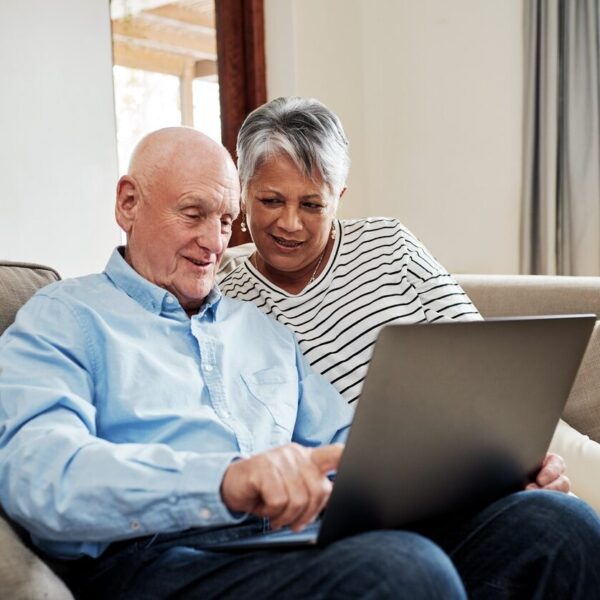 Couple looking at a laptop on the sofa