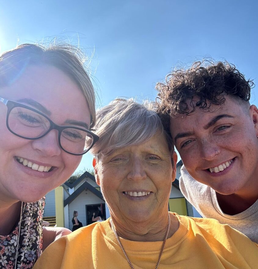 Selfie photo of three women outside in the sunshine smiling at camera