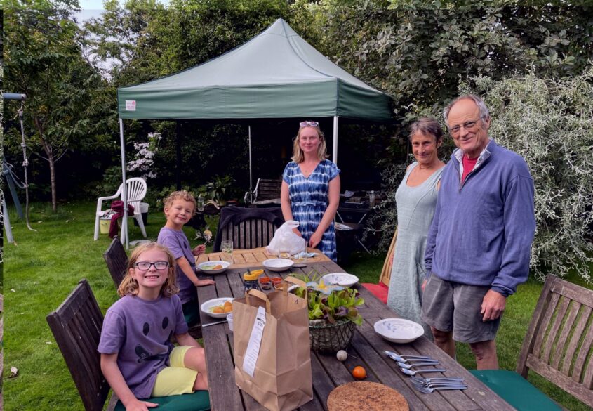 Family standing around a bench with food