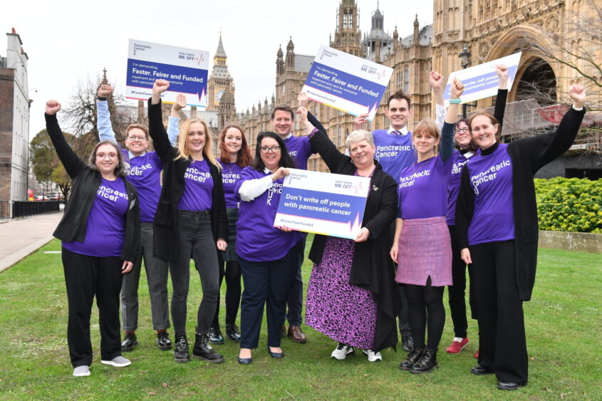 Our volunteers and staff celebrate outside the Houses of Parliament after our Don't Write Me Off event