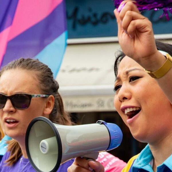 two women supporting pcuk one with a megaphone other with a flag