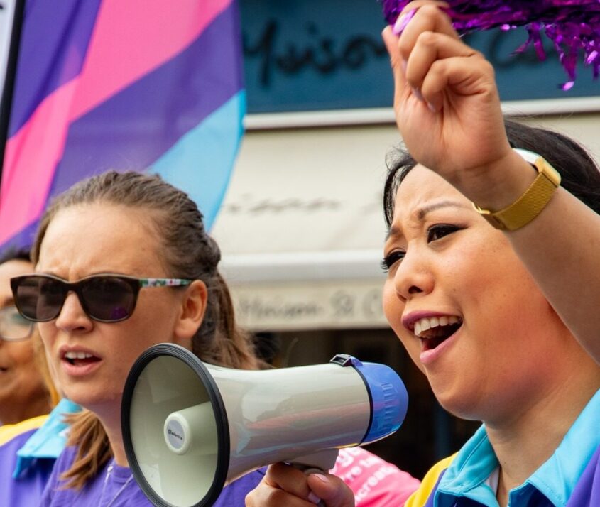 two women supporting pcuk one with a megaphone other with a flag