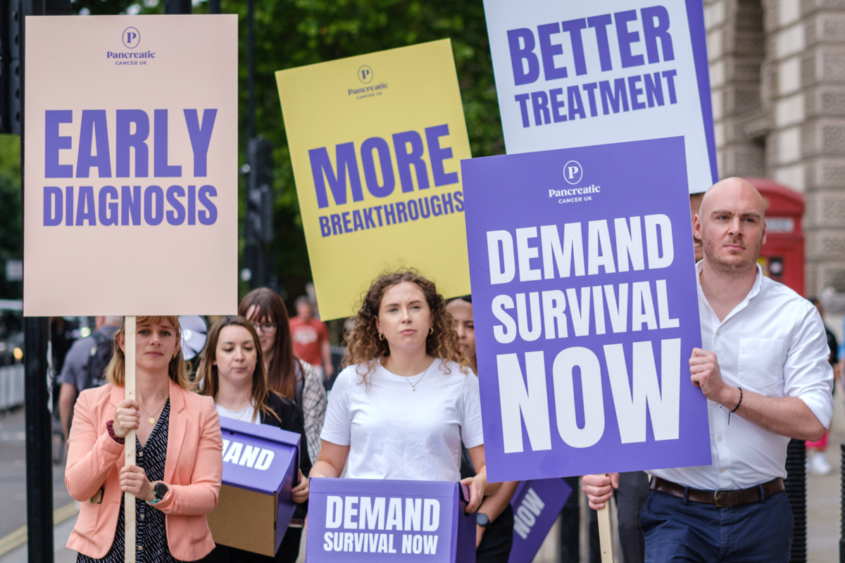 a group of people holding signs reading different things