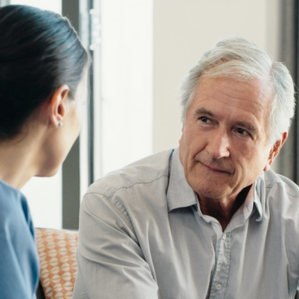 Older man talking with healthcare professional