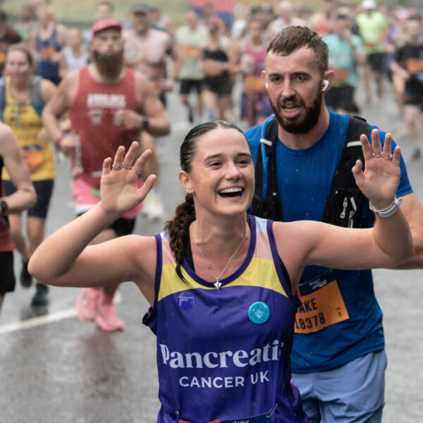 Runner in a Pancreatic Cancer UK vest waving