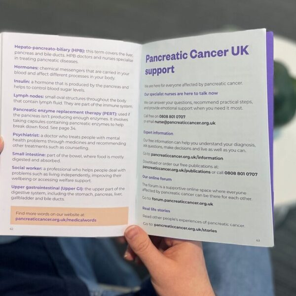 person holding a booklet with medical words to do with pancreatic cancer words