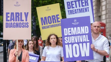 Campaigners holding placards - Early Diagosis, Better Treatment