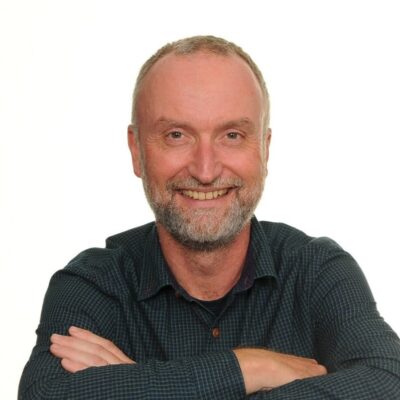 David Rose white background smiling at the camera