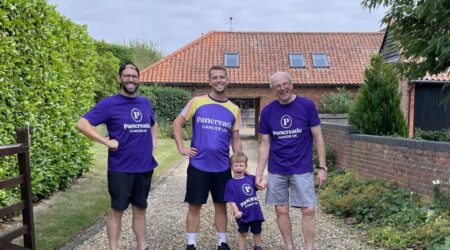 3 men and one small child wearing Pancreatic Cancer UK tops, fundraising as a family.
