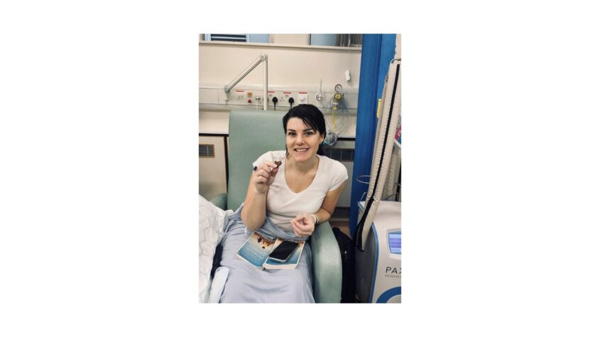 Emma sat in a hospital chair eating