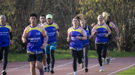 Runners on a track wearing Pancreatic Cancer UK t-shirts