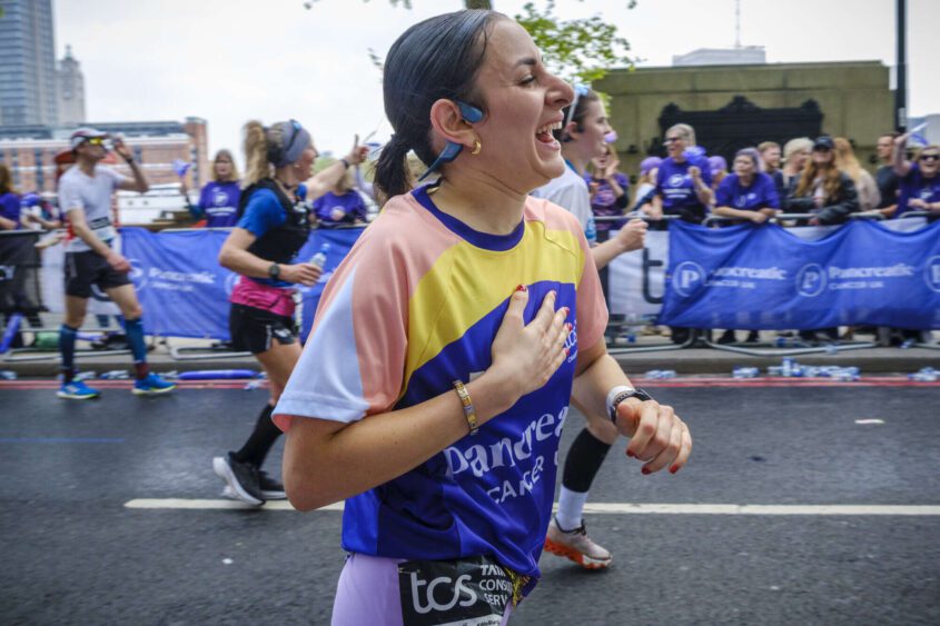 The side profile of a PCUK runner smiling