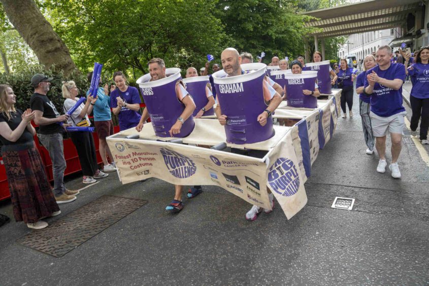 PCUK runners wearing a 10-person costume designed to look like a test tube rack