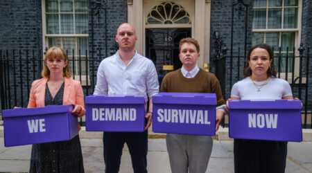 Pancreatic Cancer UK campaigners at Downing Street holding boxes reading We Demand Survival Now