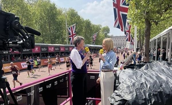 Pancreatic Cancer UK CEO Diana Jupp being interviewed by Gabby Logan next to The Mall with runners in the background