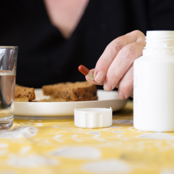 close up of a pert pill bottle and some food on a table