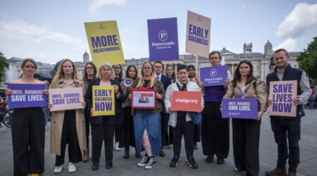 Group of protestors holding up signs.