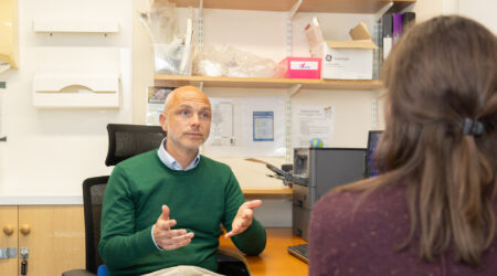 Doctor sitting in an office giving a consultation