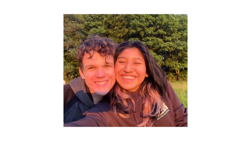 Selfie of young man and woman outside with sun shining on their faces