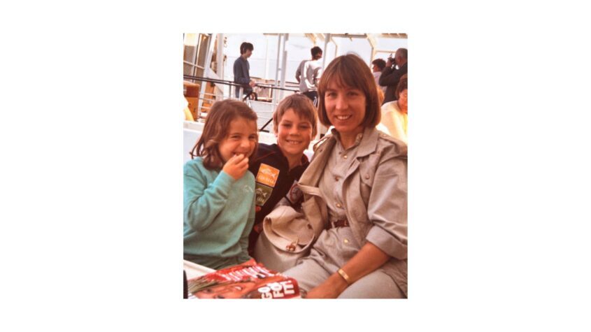 Mum and two young children smiling to camera