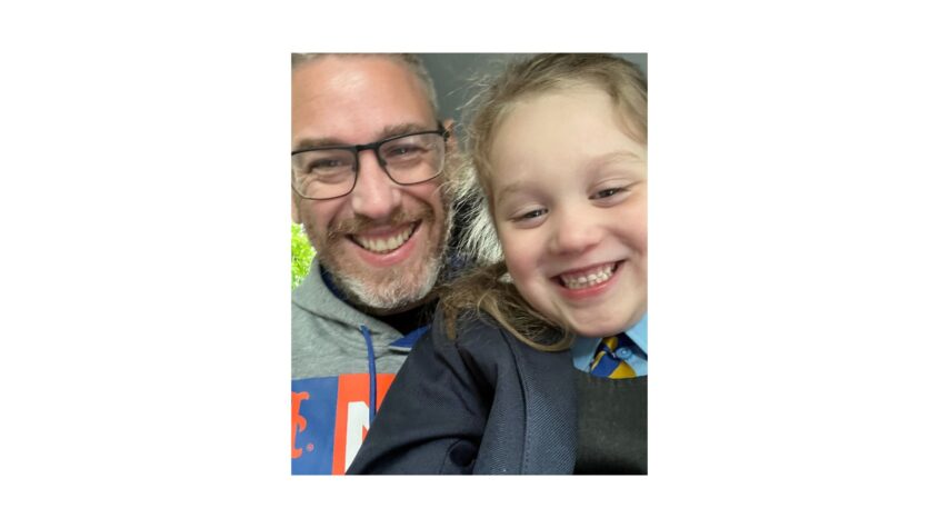 Young girl in school uniform with father in a selfie picture
