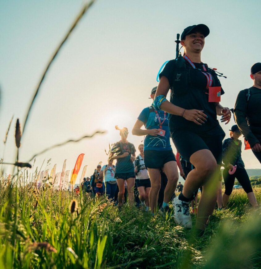 Large group of people walking through a field in the Lake District