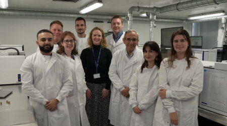A group of researchers wearing lab coats