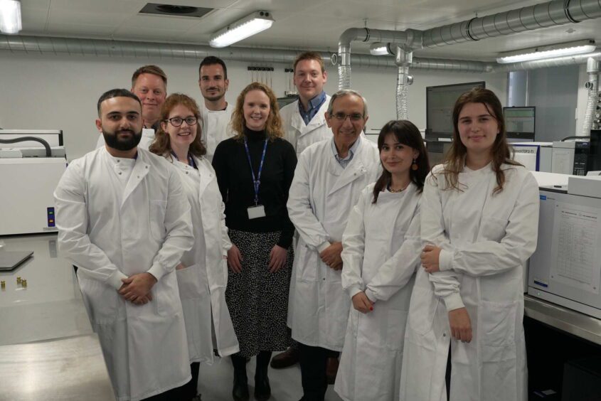 A group of researchers wearing lab coats