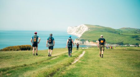 Walkers walking along the coastline of the Isle of Wight