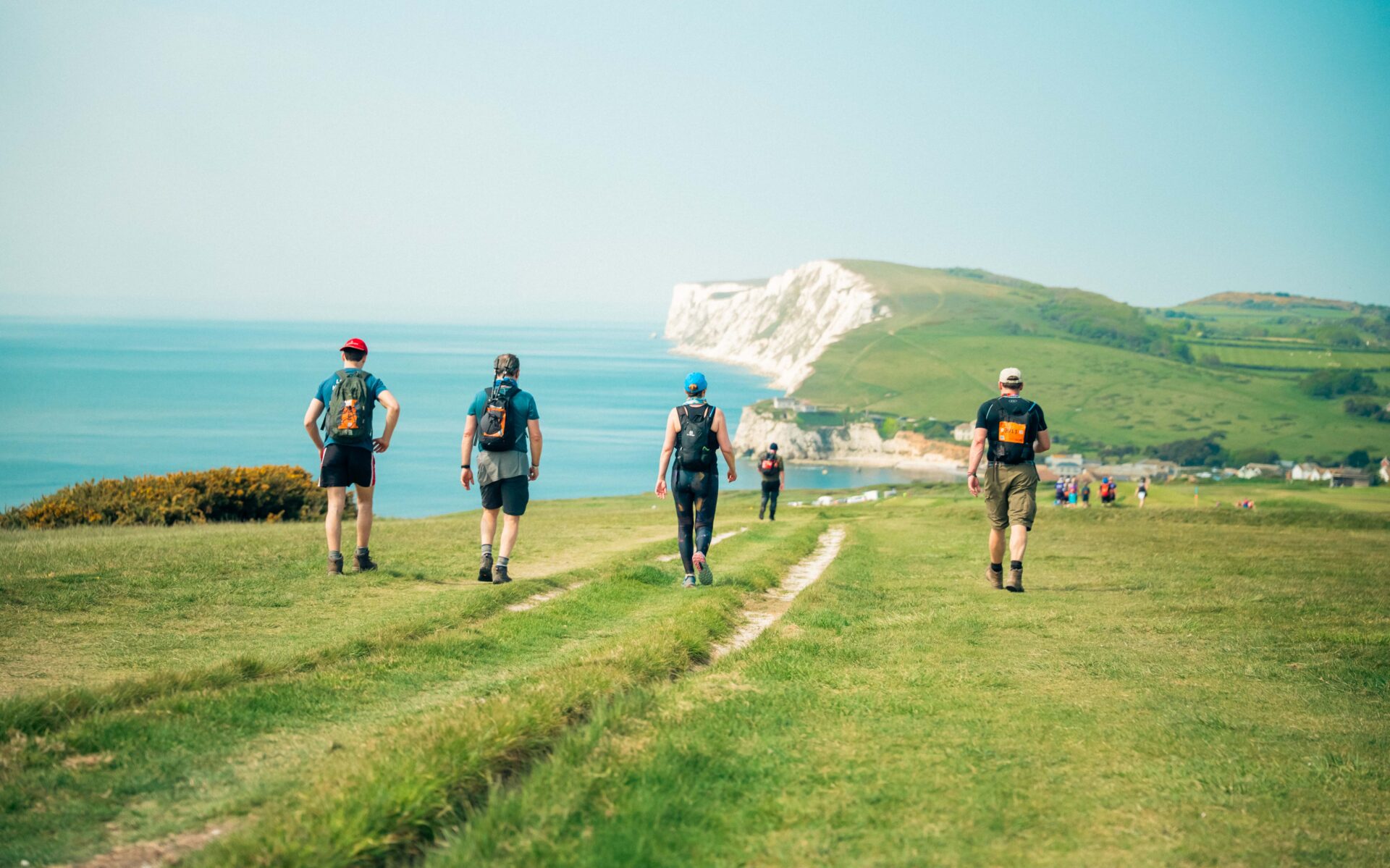 Walkers walking along the coastline of the Isle of Wight
