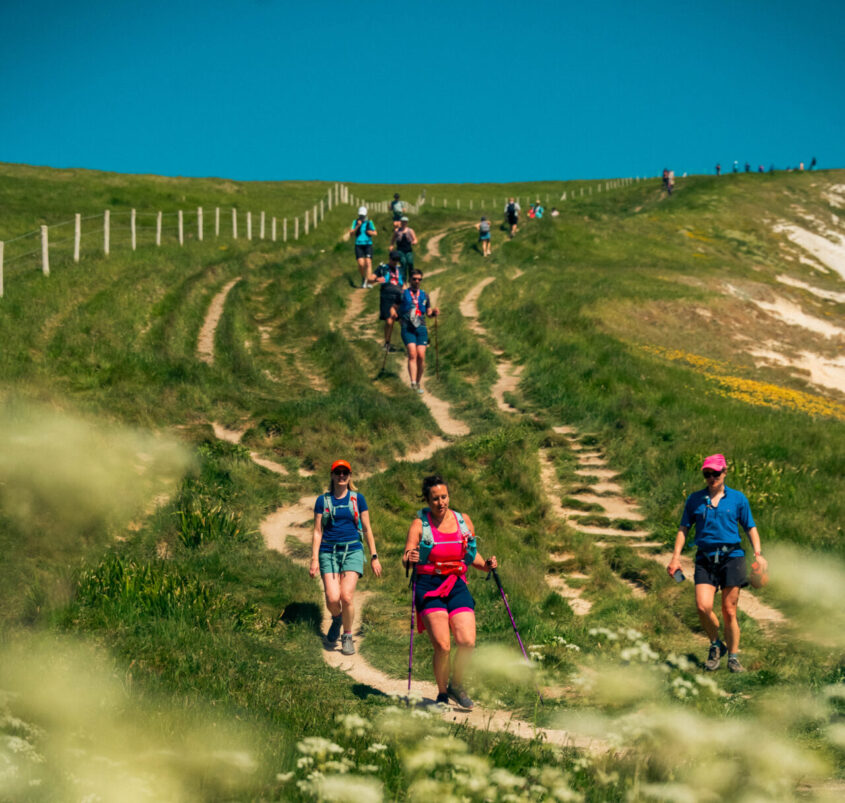 Large group of people walking down a field