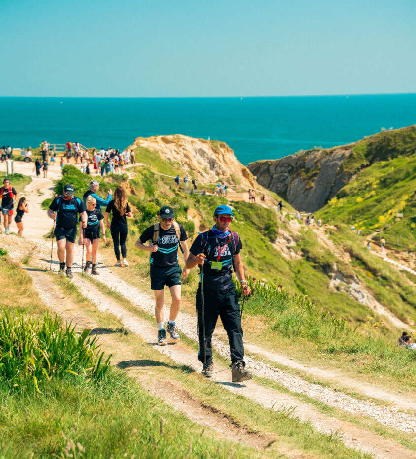 Large group of people walking along the south coast