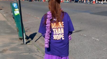 Volunteer Glenys standing at a cheer point at Brighton Marathon