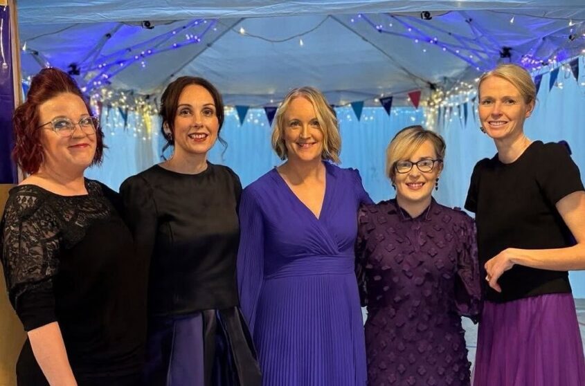 Kathleen a supporter and other women wearing purple for the  Purple Ladies Tea Party