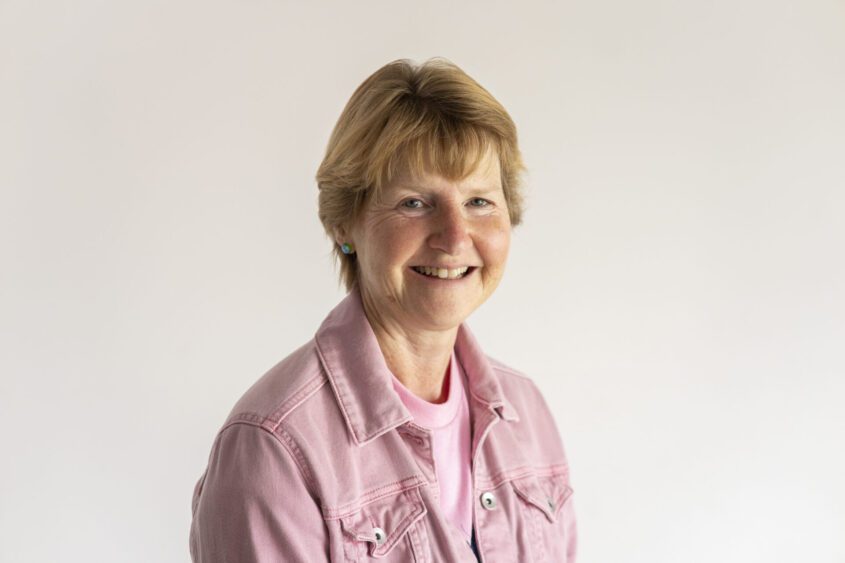 Clare in a pink shirt.