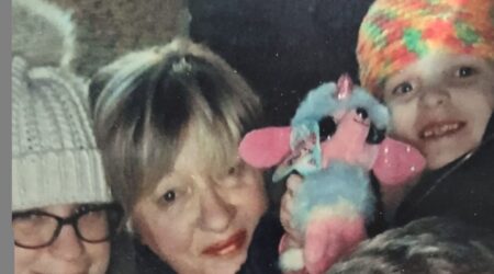 Selfie with older couple and two young children, all in winter clothes and smiling to camera