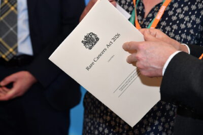 Hands holding the Rare Cancer bill 2026
