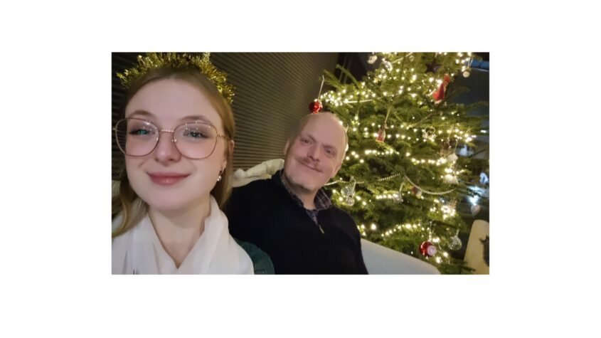 Father and daughter selfie in front of a christmas tree