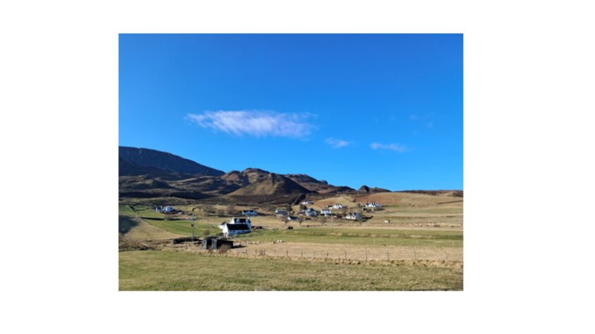 Scottish hills and cottages with blue sky