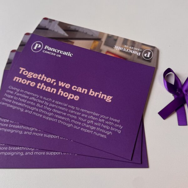Memorial donation envelopes and purple ribbon pins