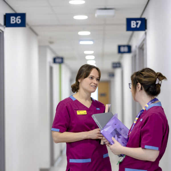 Health professionals chatting in a corridor