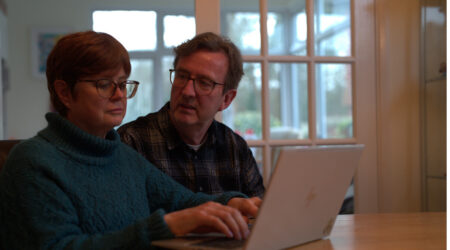 Man and woman looking at computer
