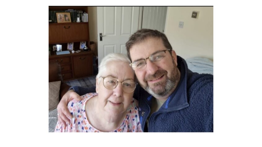 Older woman hugging her son for a selfie